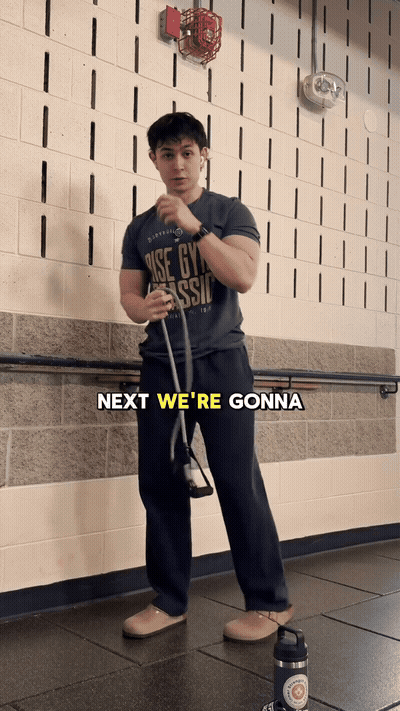 Next, we're gonna grab a band and then warm up your rear delts a littl