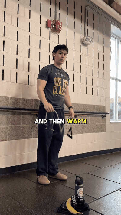 Next, we're gonna grab a band and then warm up your rear delts a littl